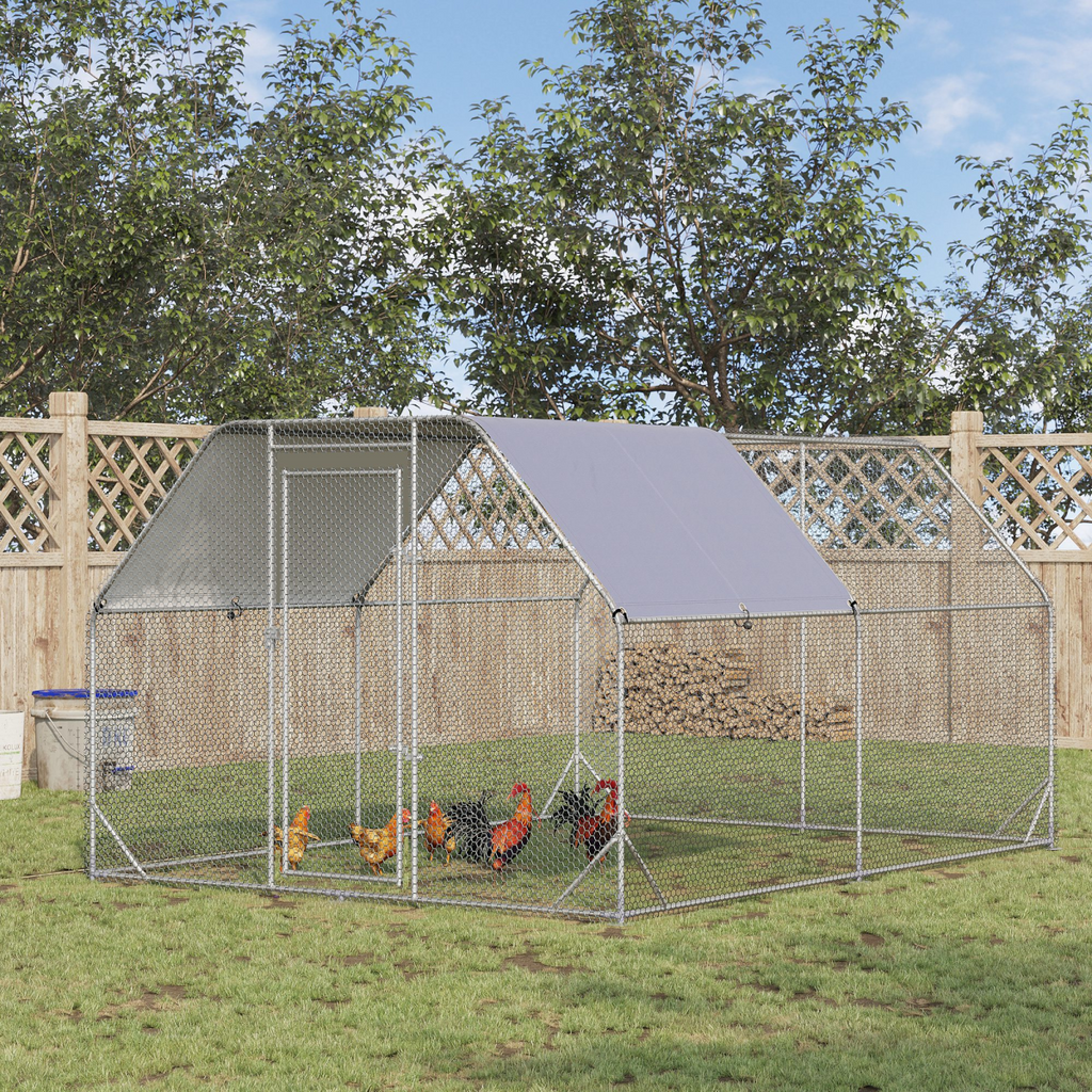 Outdoor chicken coop with a grey roof in a garden setting
